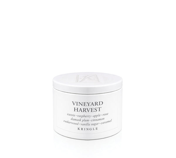 A white cylindrical candle tin of Kringle Vineyard Harvest scented candle on a seamless white background.