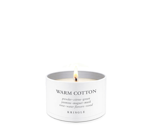 Candle tin labeled 'Warm Cotton' by Kringle Candle on a white background.