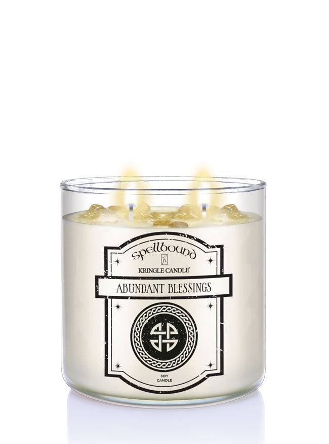 Two-wick candle labeled 'Abundant Blessings' by Spellbound on a white background
