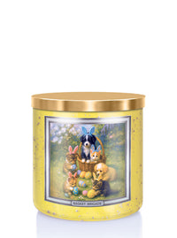 Decorative candle with a festive design featuring animals and Easter eggs on a yellow background.