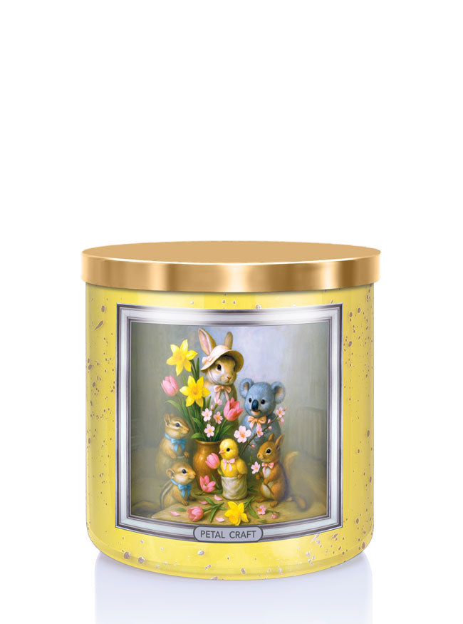 Decorative candle with cartoon animals and flowers in a yellow holder