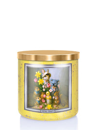 Decorative candle with cartoon animals and flowers in a yellow holder