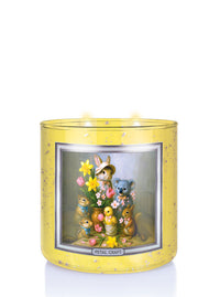 Decorative candle with cartoon animals and flowers in a yellow holder