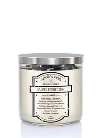 Candle labeled 'Sacred Protection' with a silver lid on a white background