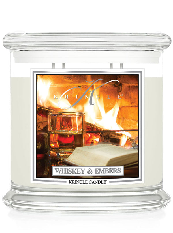 Unlit XL 4-wick candle. Label shows a whiskey glass and book near a bright fireplace.