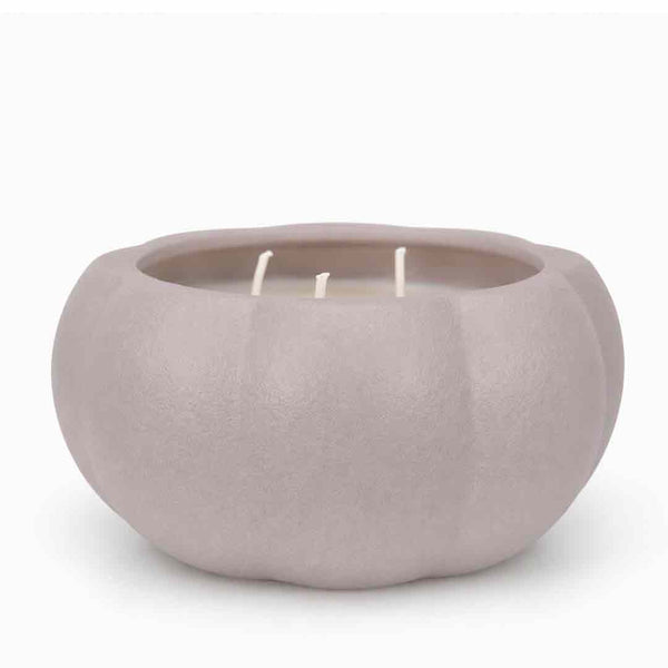 A three-wick candle in a matte, rounded pumpkin-shaped container with a light taupe-gray color, set against a plain white background.