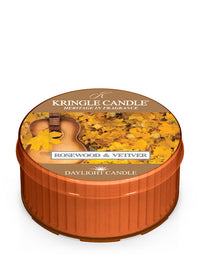 Unlit DayLight candle in "Rosewood & Vetiver" scent. Label shows a guitar and autumn leaves.