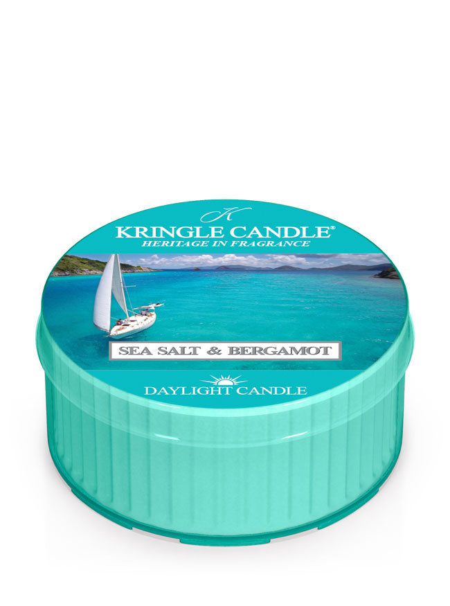 Teal candle tin with ocean scene, sailboat, and text 