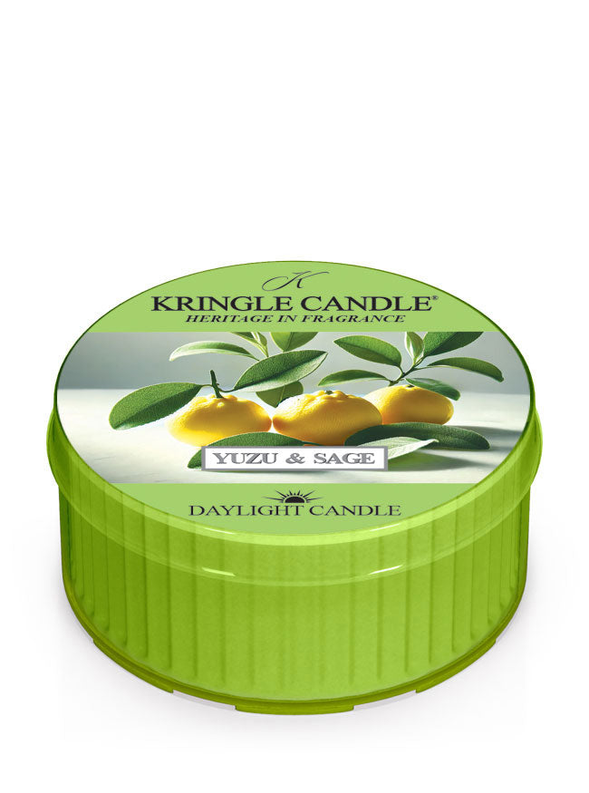 Green tin of Kringle Candle with a Yuzu and Sage design, featuring yellow fruits and green leaves.