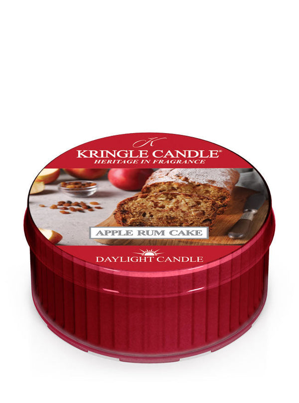 DayLight candle in red cup; label shows sliced apple rum cake with whole apples and spices in the background.