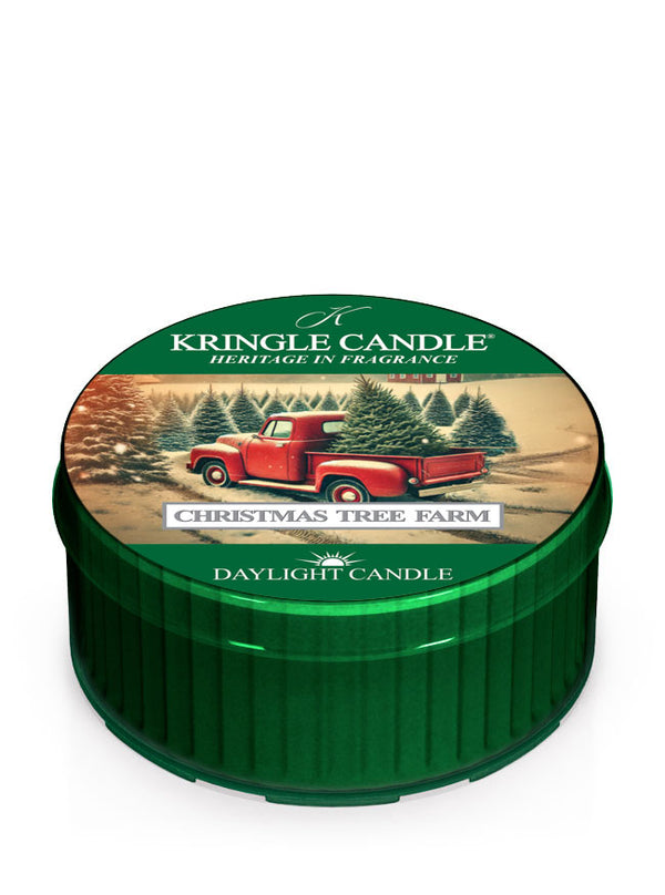 Kringle Candle daylight with "Christmas Tree Farm" design, featuring a red truck and evergreen trees on the lid.