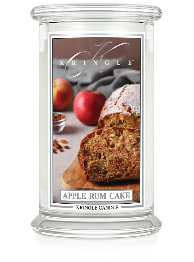 Unlit Apple Rum Cake 2-Wick candle. Label shows apple rum cake slices on a board with apples in the background.