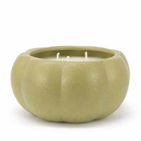 A three-wick candle in a ribbed, pumpkin-shaped ceramic pot with a matte sage green finish, set against a plain white background.