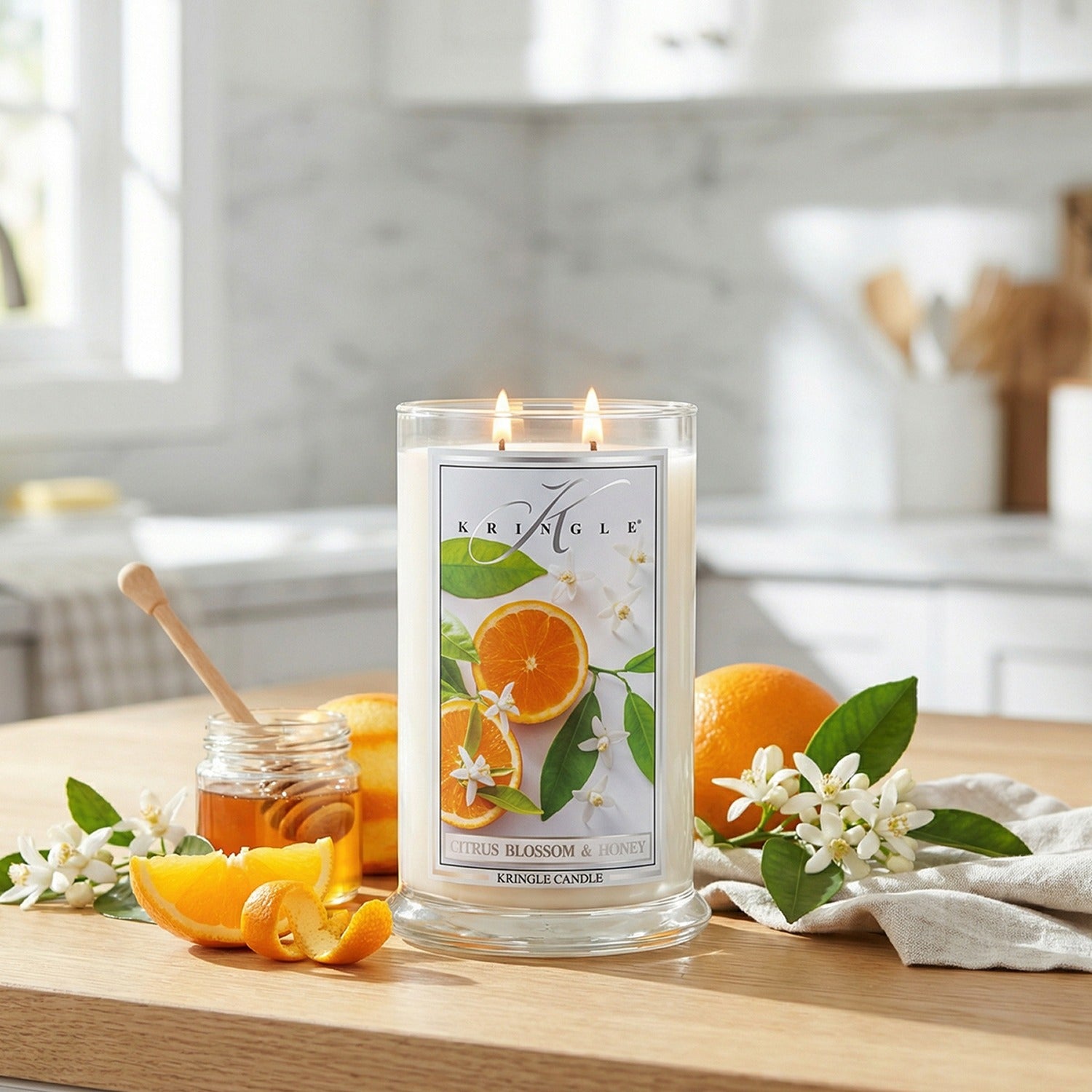 Kringle Candle with oranges and honey on a wooden table
