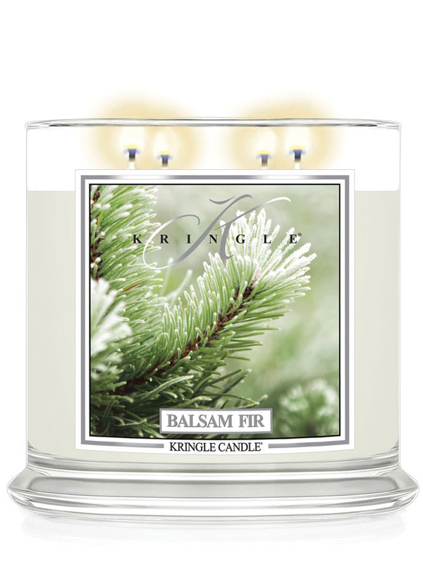 Kringle Candle with 4-wick lit candle with 'Balsam Fir' label featuring a evergreen branch design.