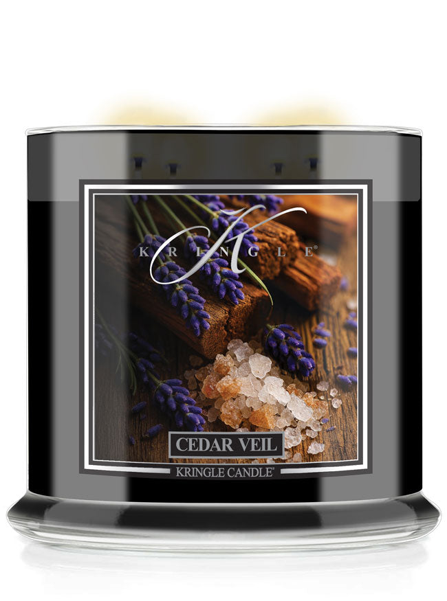 Kringle Candle Cedar Veil 4-wick candle with lavender and wood design on a black container.