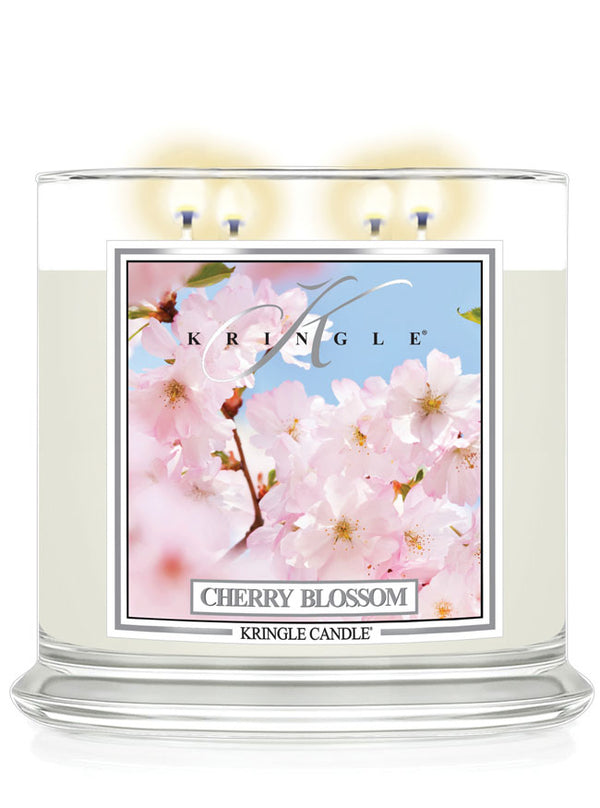 Kringle Candle Cherry Blossom 4-wick scented lit candle with cherry blossom design on the label.