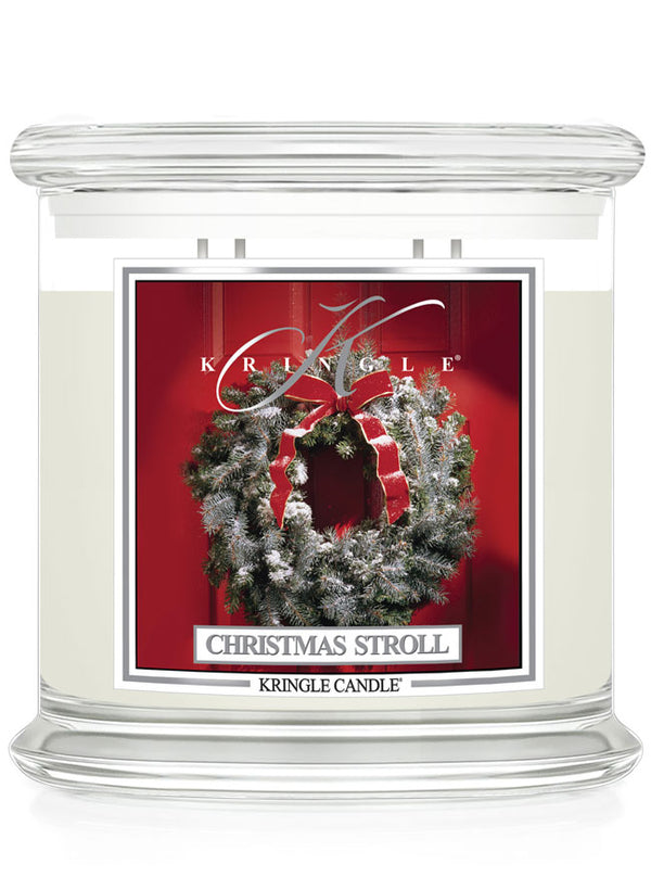 Kringle Candle Christmas Stroll candle with wreath design on a red background