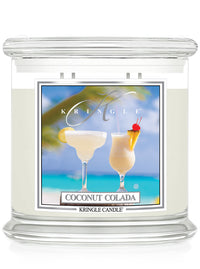 Kringle Candle Coconut Colada scented candle with a tropical design on the label.