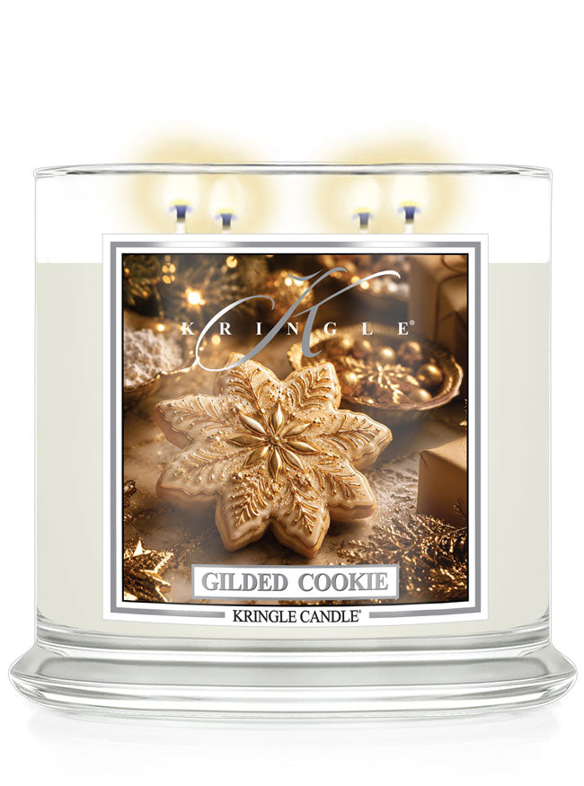 Kringle Candle Gilded Cookie 4-wick lit candle on a white background with a label with cookies.