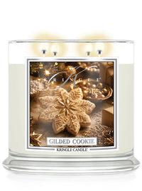 Kringle Candle Gilded Cookie 4-wick lit candle on a white background with a label with cookies.