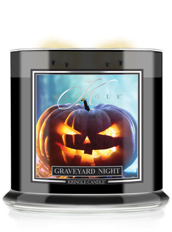 A Kringle Candle jar labeled 'Graveyard Night' with a black container, clear glass base, and a front label showing a glowing jack-o'-lantern against a blue background.