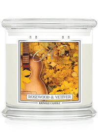 Unlit XL 4-wick candle labeled "Rosewood & Vetiver" with an image of a guitar surrounded by yellow leaves.