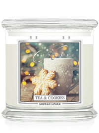 Kringle Candle with 'Tea & Cookies' label featuring a mug and cookie on a white background