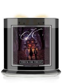 A Kringle Candle jar candle with a black container and a front label featuring a spooky haunted-house scene at night. The label reads 'KRINGLE', 'TRICK OR TREAT', and 'KRINGLE CANDLE'.
