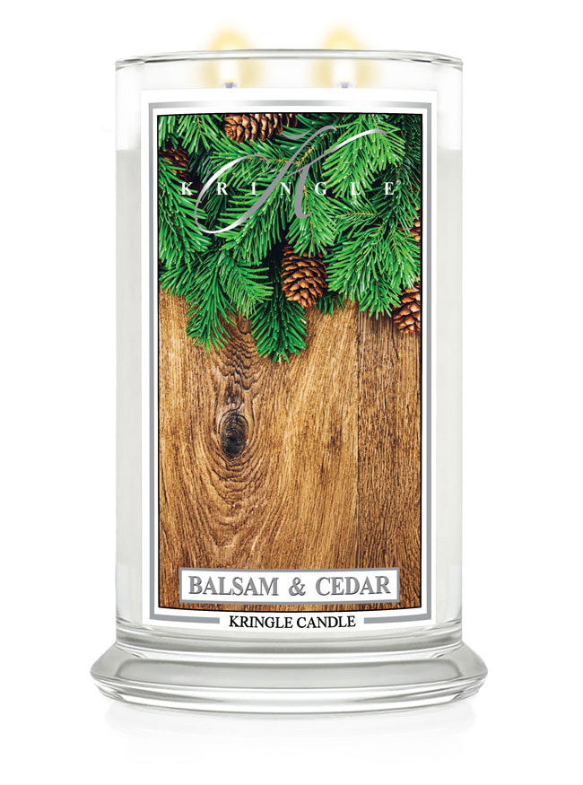 Kringle Candle with 'Balsam & Cedar' label on a wooden surface
