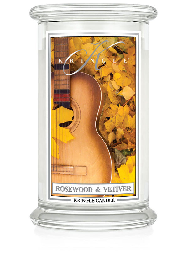 Unlit large 2-wick candle in a clear jar with label depicting a guitar and autumn leaves. Fragrance: Rosewood & Vetiver.