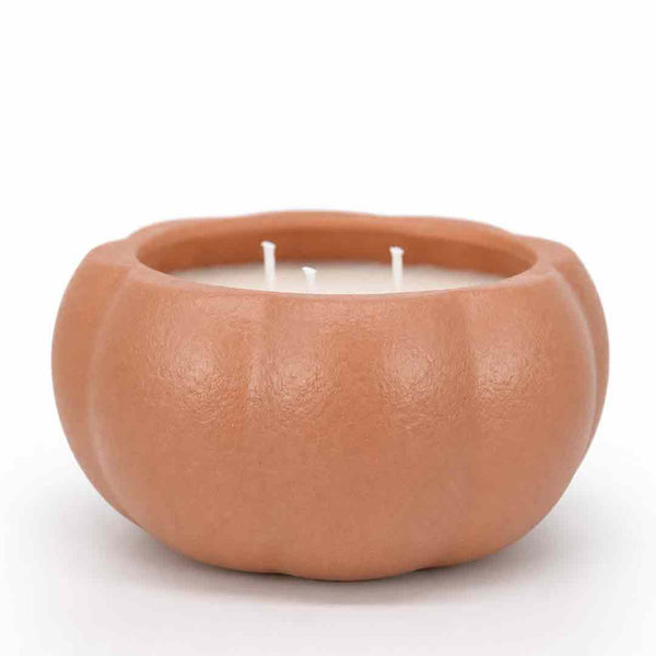 A two-wick candle in a sculpted, pumpkin-shaped terracotta container with a matte, textured finish, set against a plain white background.