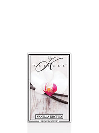Kringle Candle Vanilla Orchid air freshener, designed for use in cars or small spaces. The packaging features a white orchid with a pink and yellow center resting on a vanilla bean, set against a rustic wood background. The Kringle Candle logo is displayed at the top, with the scent name ‘Vanilla Orchid’ printed below.