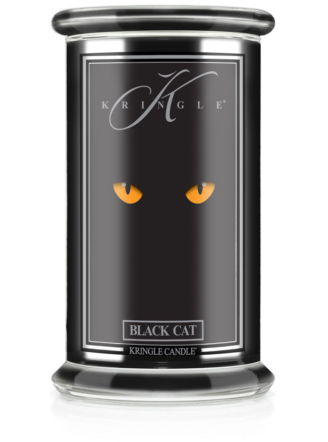 Unlit Halloween candle in glass jar. Label shows glowing yellow cat eyes on black background. Text reads "Black Cat."