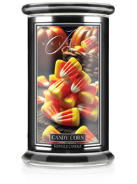 Unlit Halloween candle in "Candy Corn" fragrance. Label shows a pile of vibrant candy corn pieces on a dark background.