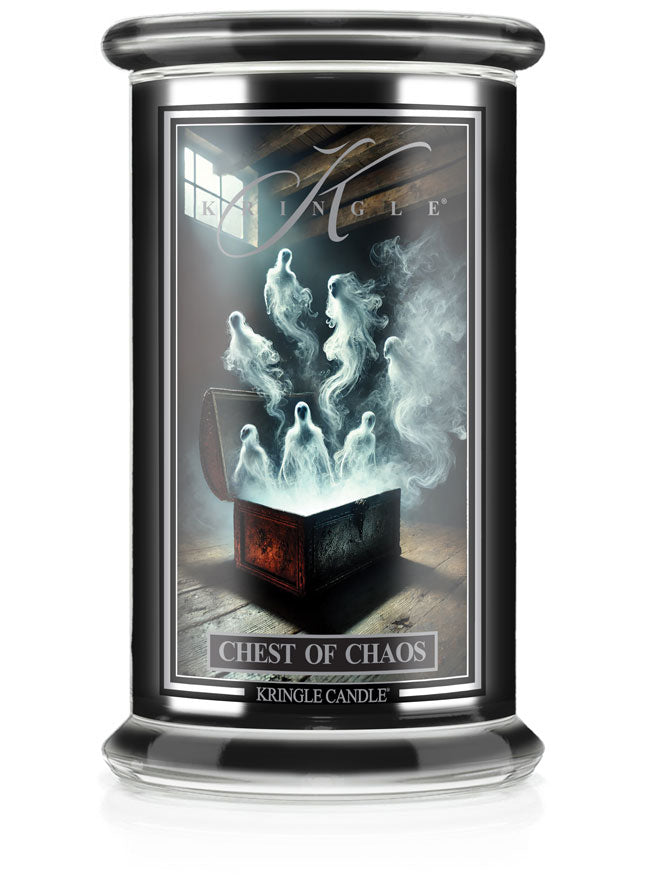 Unlit Halloween candle in fragrance "Chest of Chaos." Label shows ghostly figures emerging from an open chest.