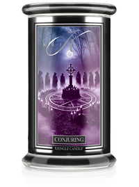 Candle jar labeled "Conjuring," unlit. Image depicts hooded figures around a mystical circle in a forest under moonlight.