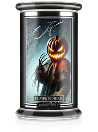 Unlit "Pumpkin Head" candle in jar; label shows a scarecrow with glowing pumpkin head and claw-like hands in a misty forest.