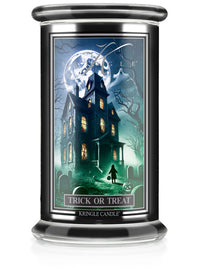 Unlit Halloween candle labeled "Trick or Treat" with a spooky house scene and full moon on the label.