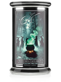 Unlit Halloween candle, "Witches Cauldron." Label shows witches around a steaming cauldron in a forest under a full moon.