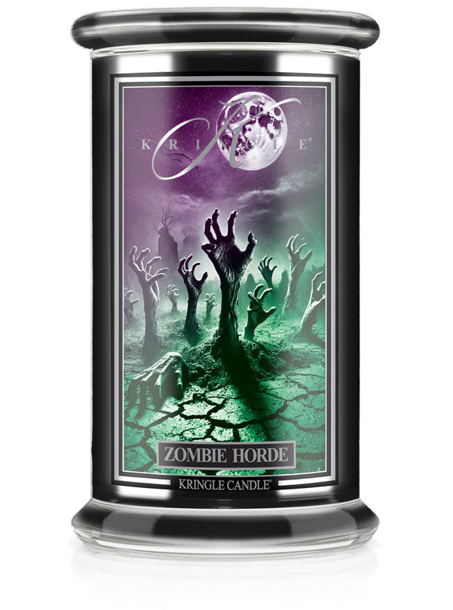A large candle jar labeled "Zombie Horde," unlit, features eerie zombie hands rising from a cracked, greenish landscape.