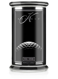 Unlit Reserve candle in "Tee Time" fragrance. Label shows a close-up of a golf ball texture on a sleek black jar.