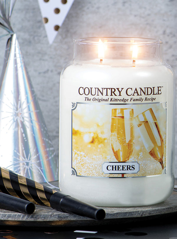 Cheers | 2-wick Soy Candle with a celebration background for New Year's - Kringle Candle Company